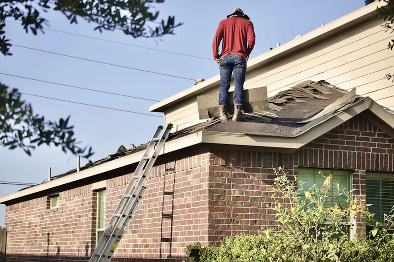 Professional roofer working on a residential roof in Booker Dairy Plantation Park
